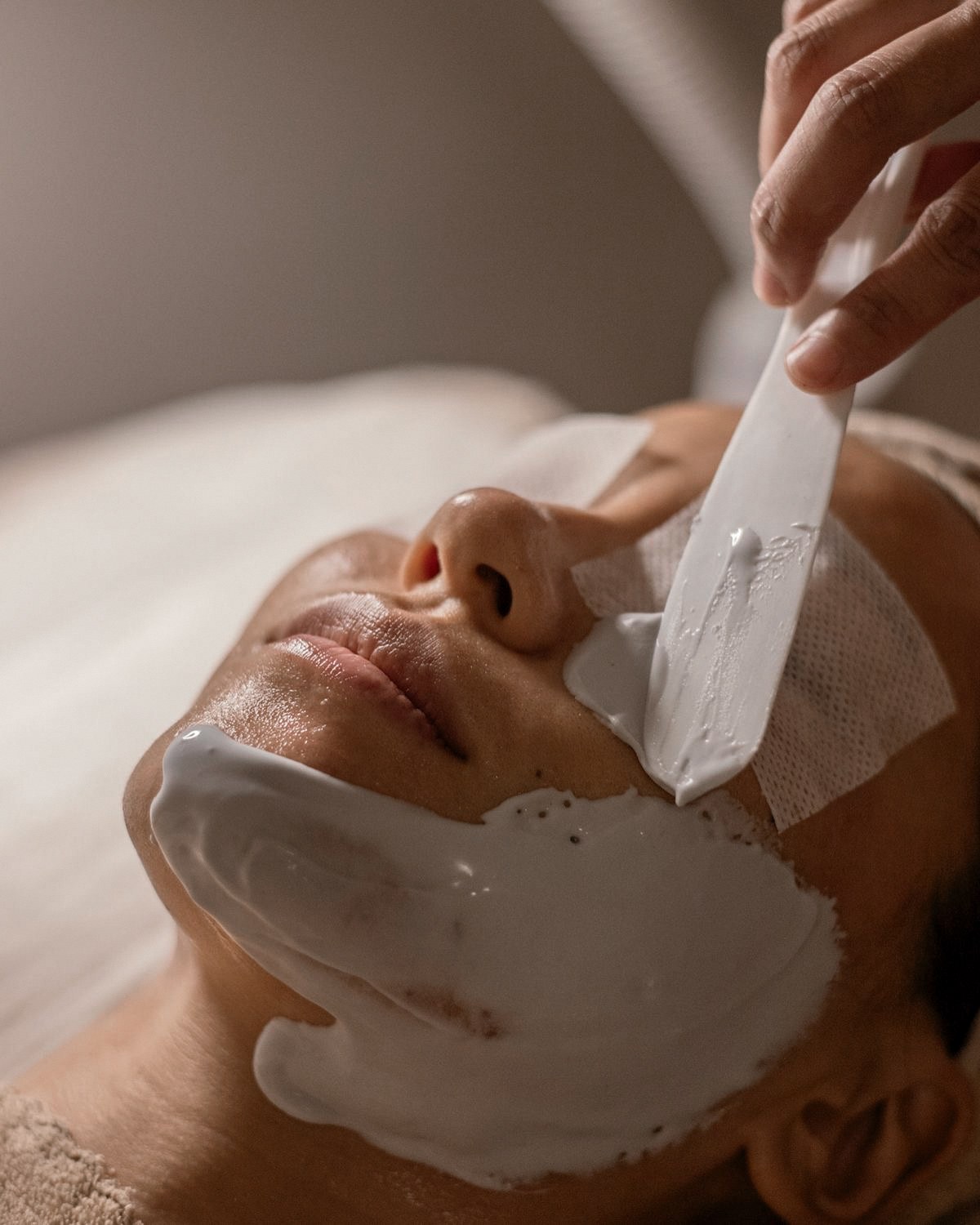 Treatment mask being applied during a SKYNN clinical facial in Albion, Brisbane