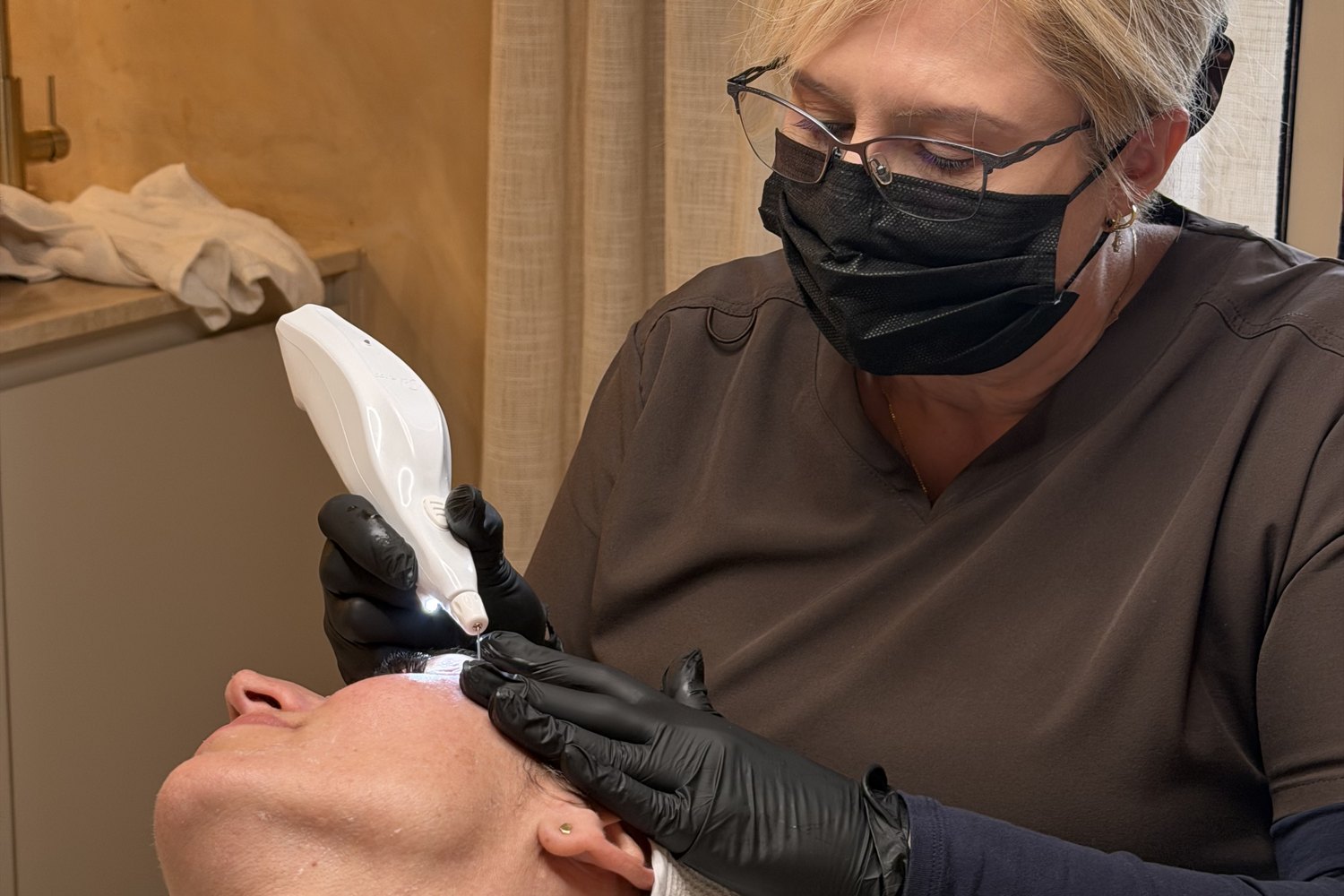 Clinical skin treatment in progress at SKYNN — hands-on dermal care, Albion, Brisbane